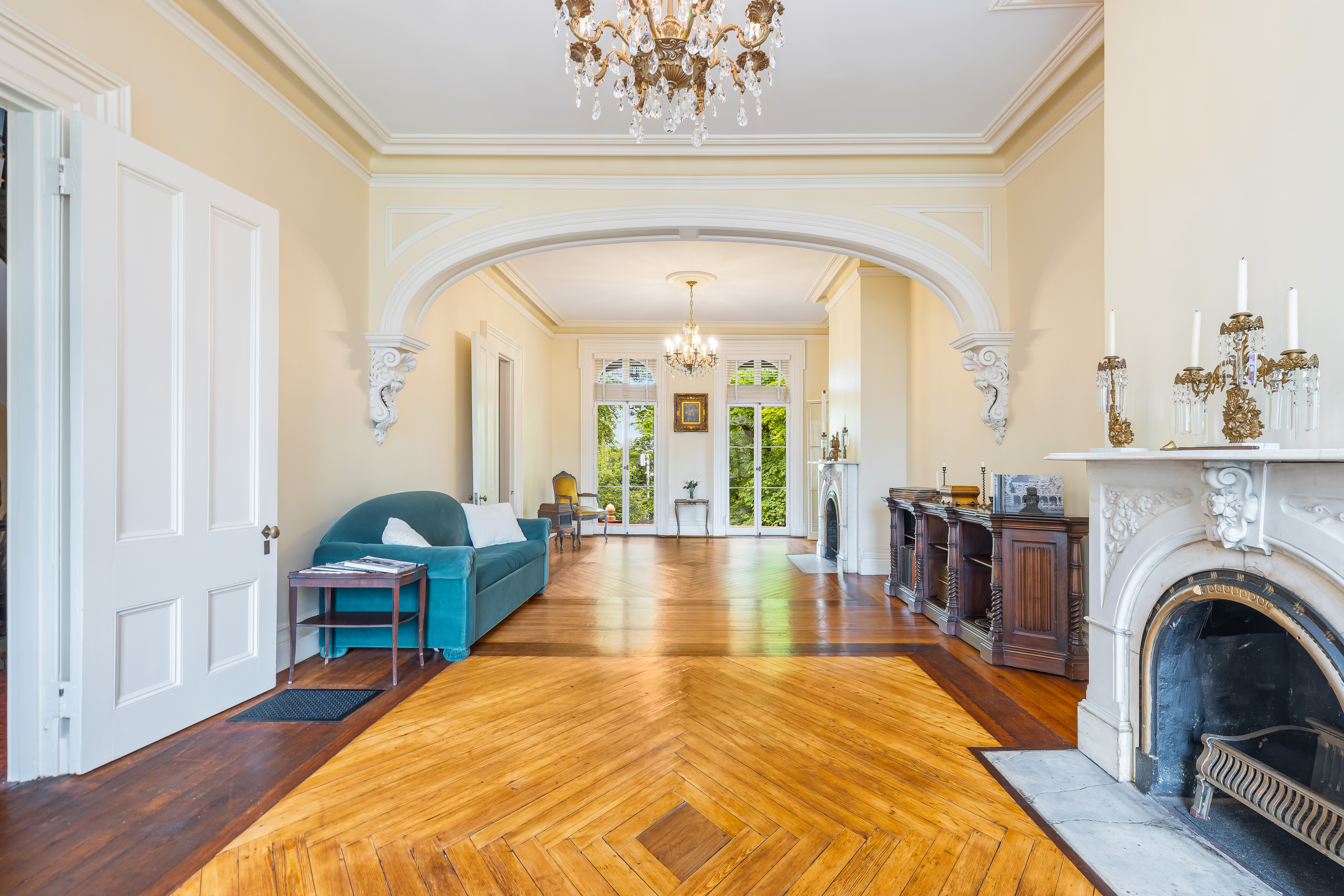 Double parlor with chandelier and fireplace