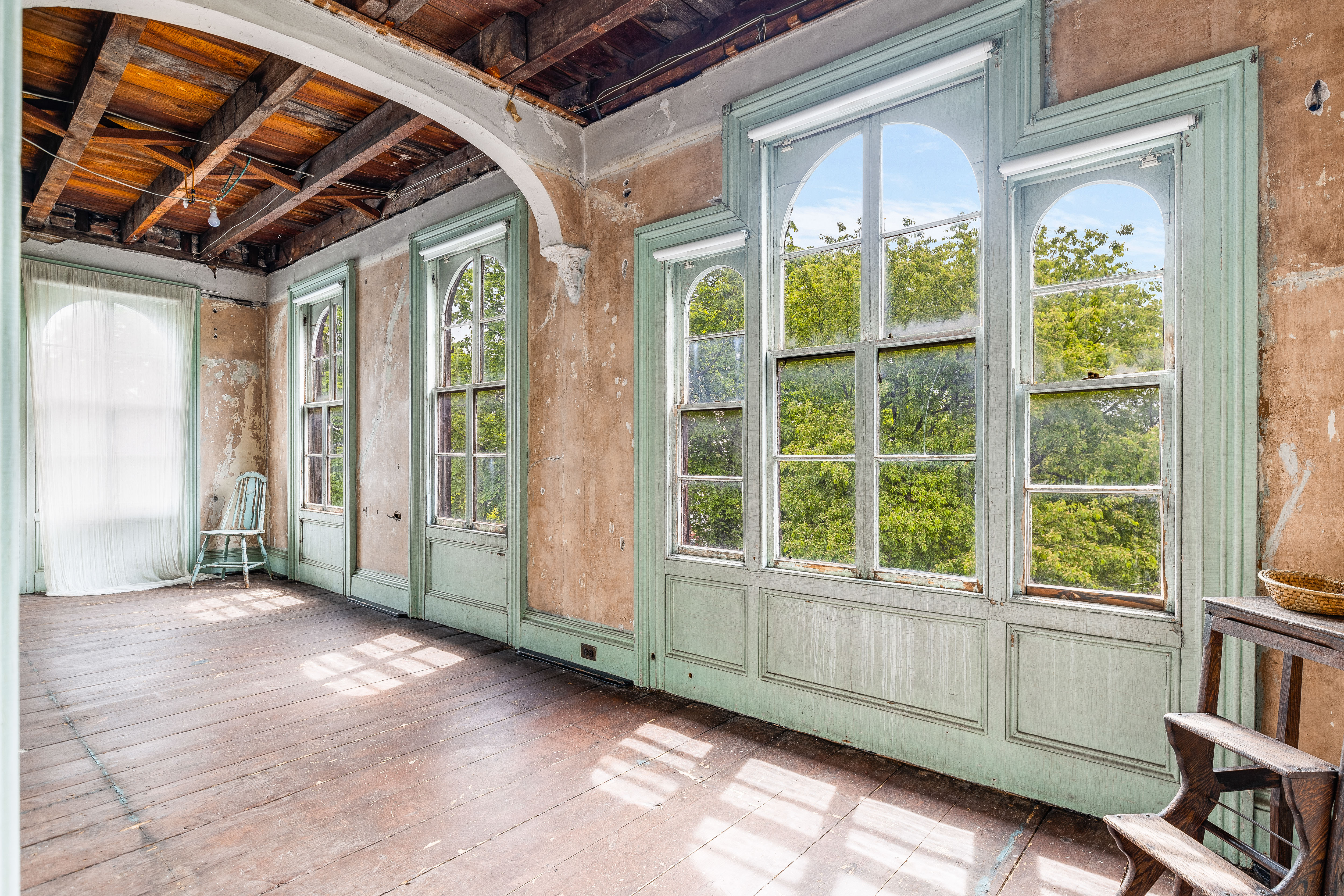 Upper floor mint green windows exposed beams