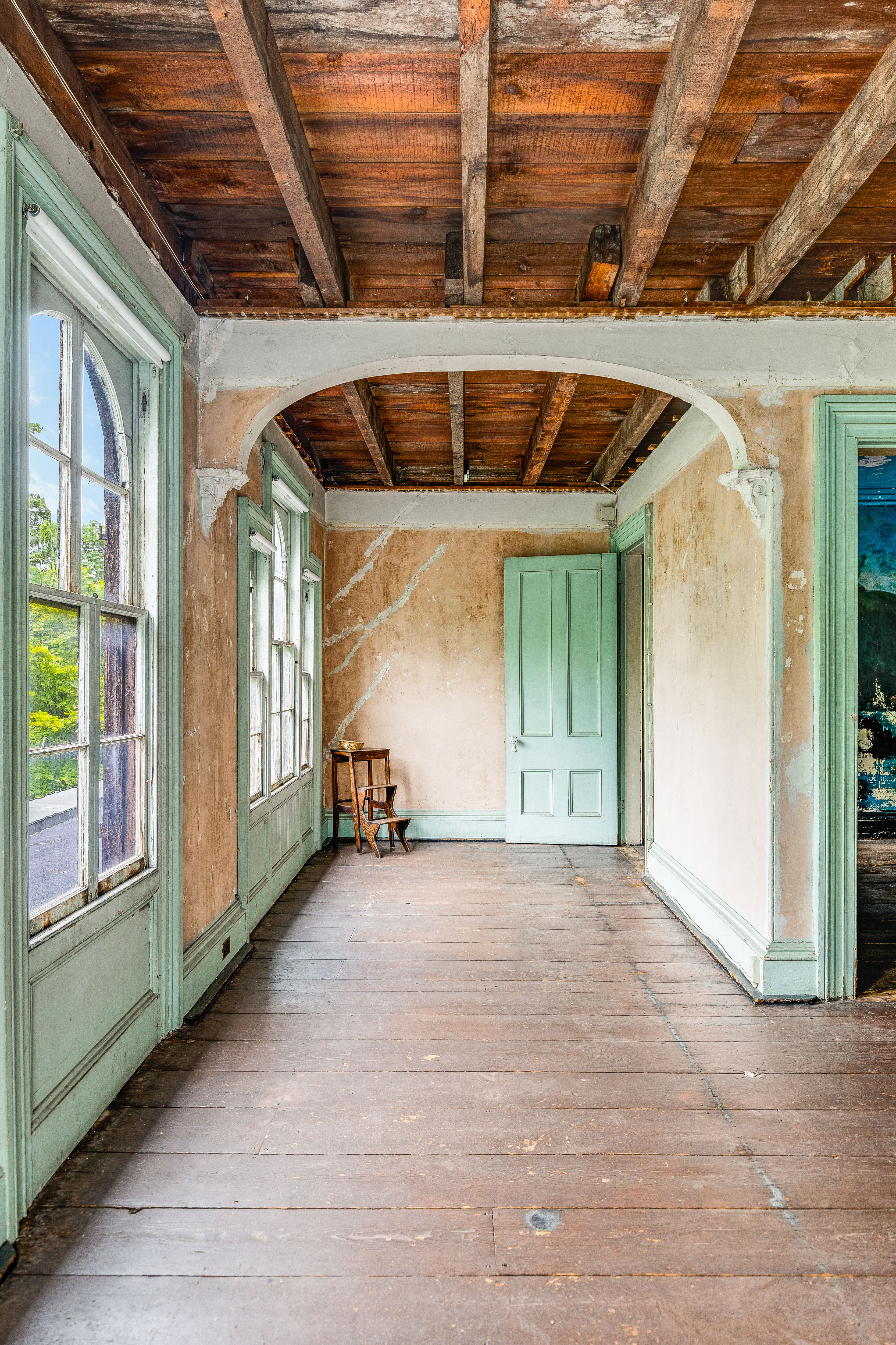 Upper floor hallway with mint green windows