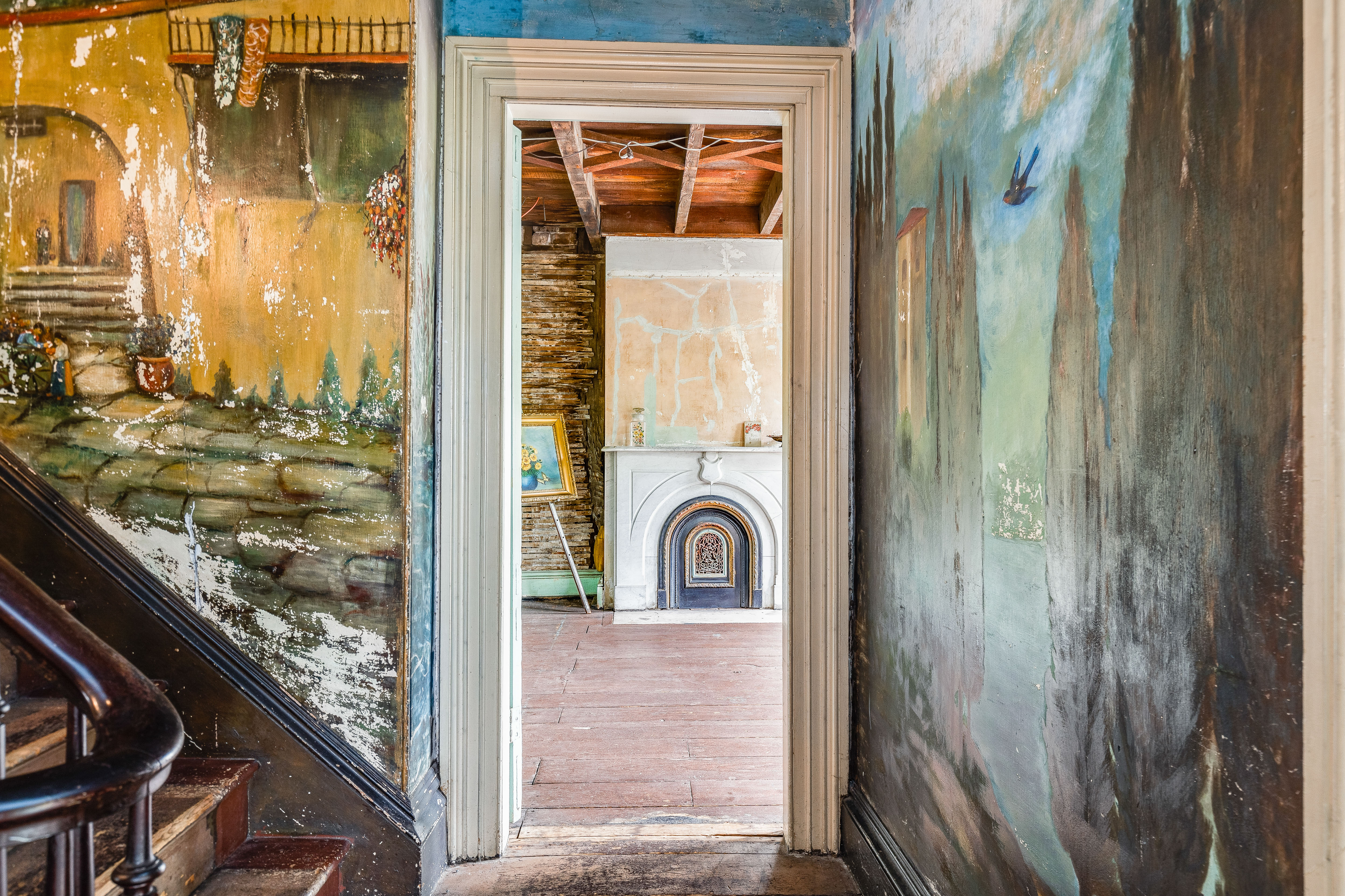 Hallway corridor with murals on both walls