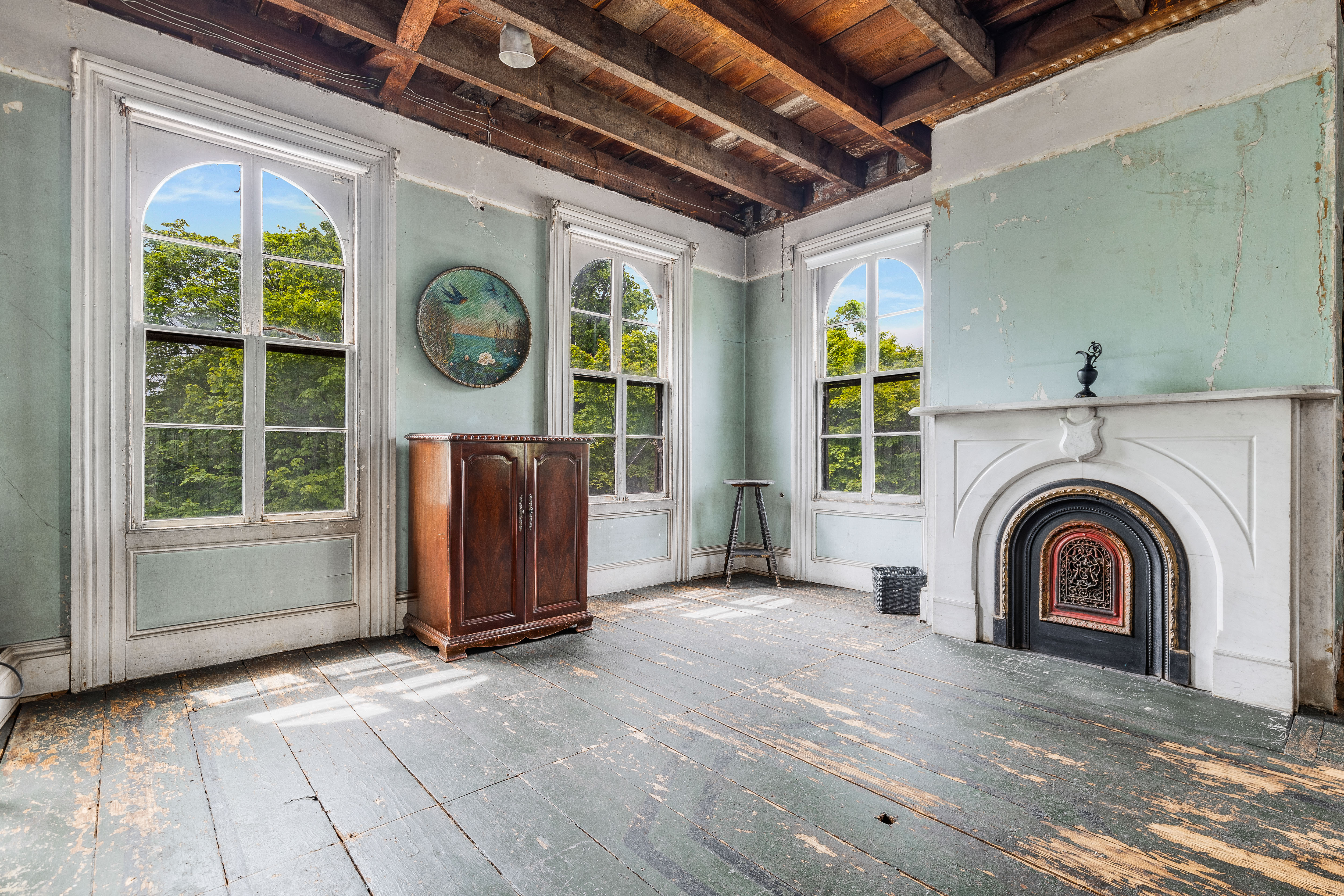 Sage green room with arched windows