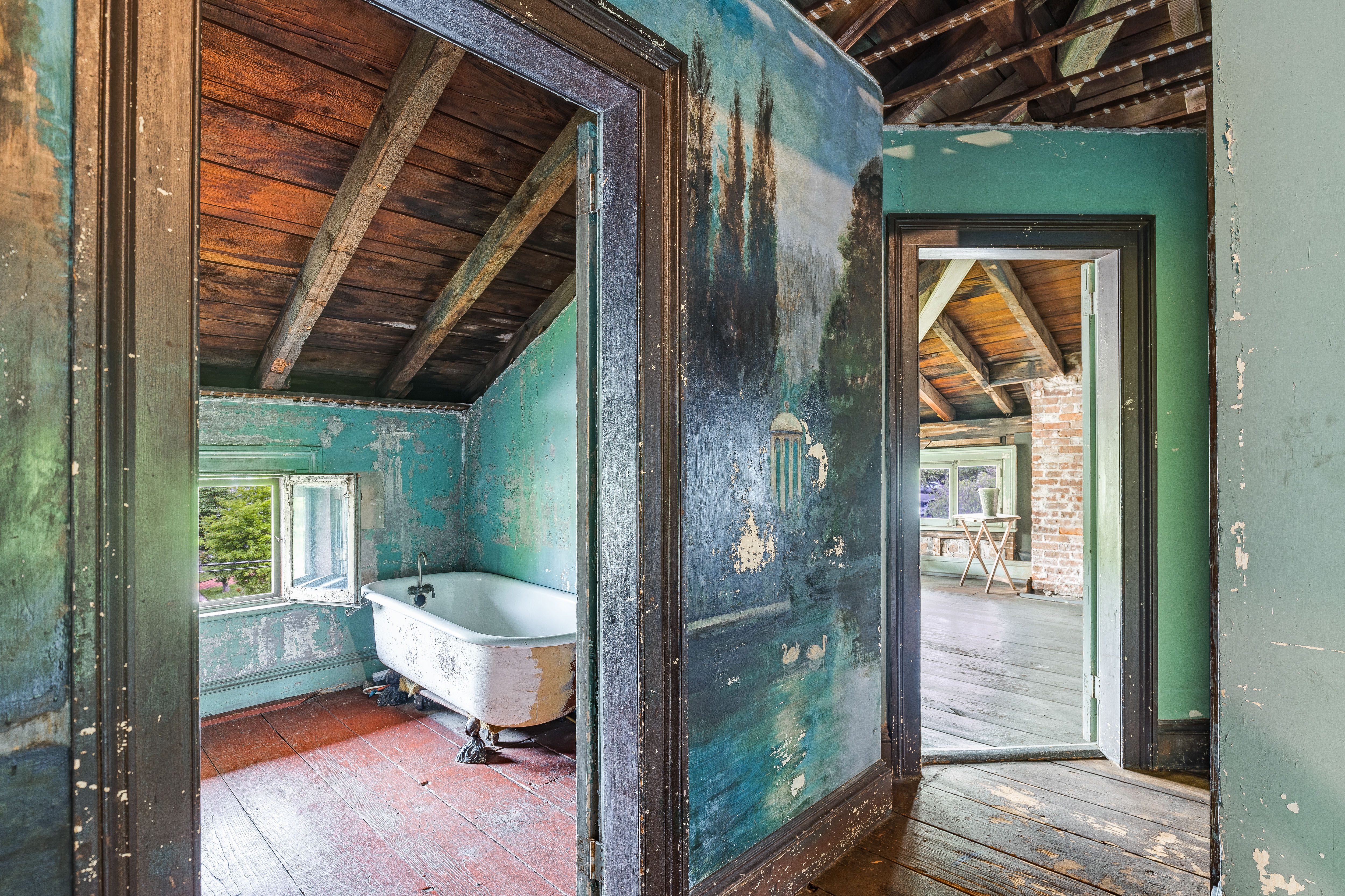 Swan lake mural on door frame with clawfoot tub