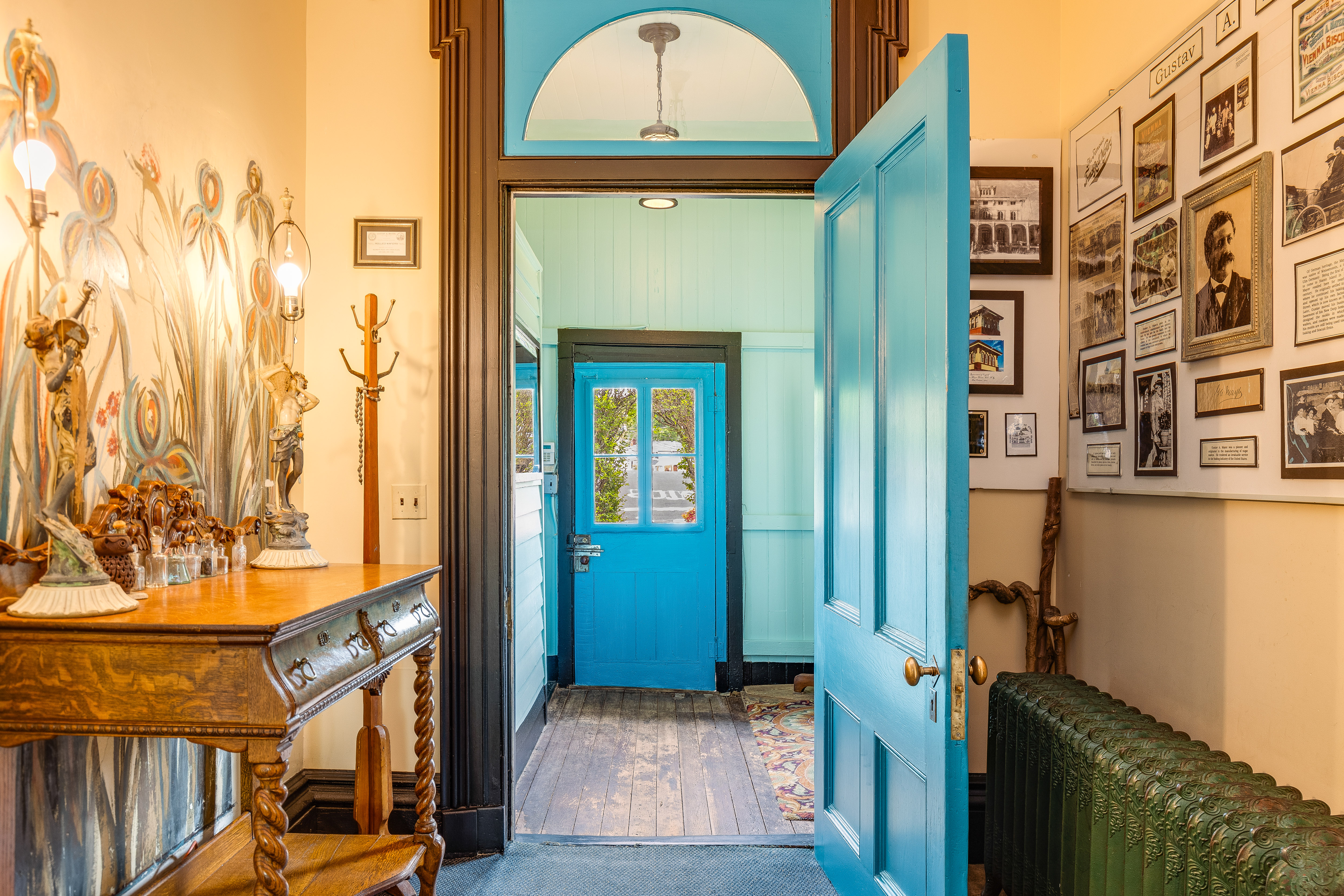 Front entryway with blue door and photo wall
